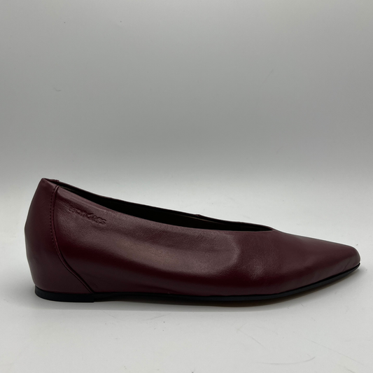 Burgundy leather flat shoe on a gray background