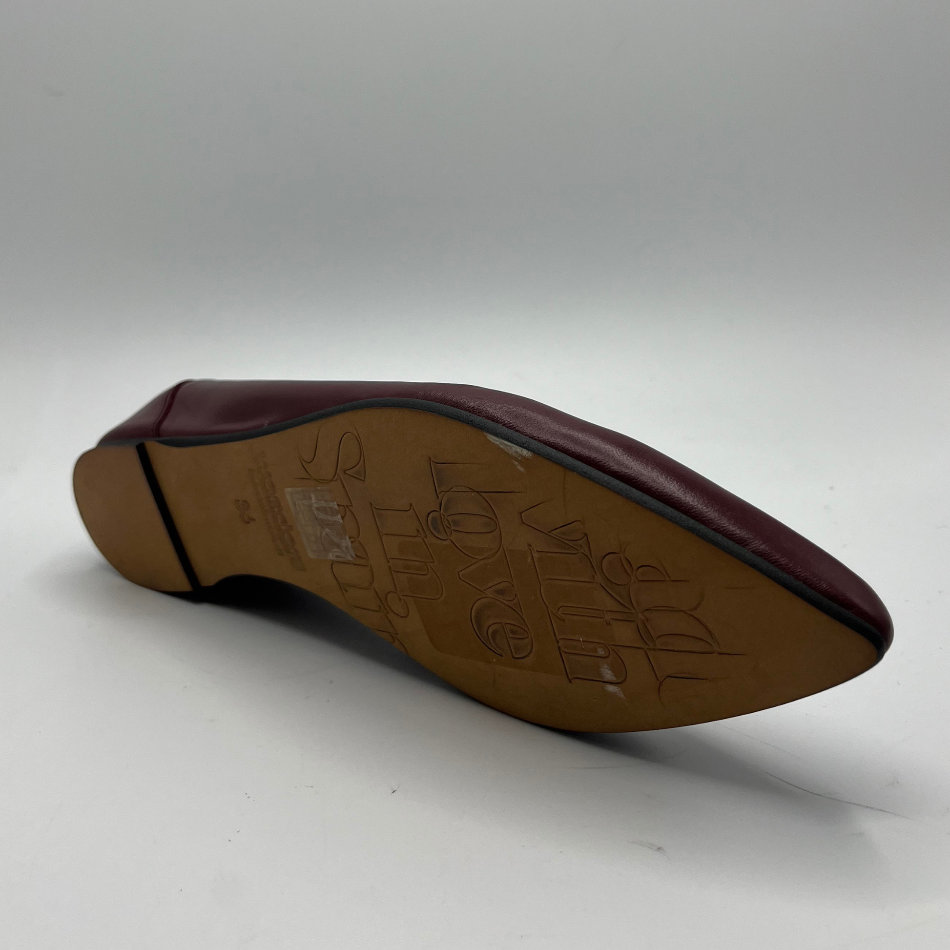 Brown shoe sole with brand logo on a white background