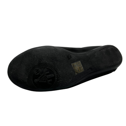 Bottom view of black leather ballet flat with bow detail and subtle heel