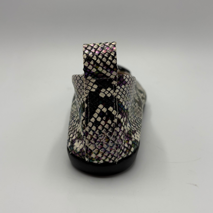 Snakeskin-patterned slip-on shoe on a gray background