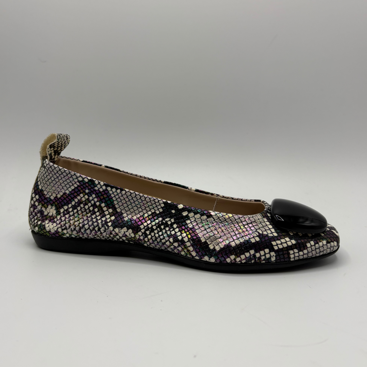 Multicolored patterned flat shoe on a gray background