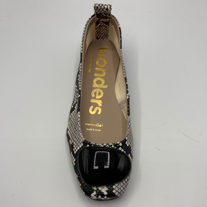 Patterned flat shoe with 'wonders' branding on a gray background