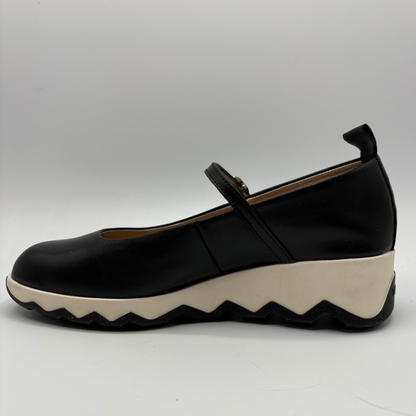 Black shoe with a white sole on a gray background