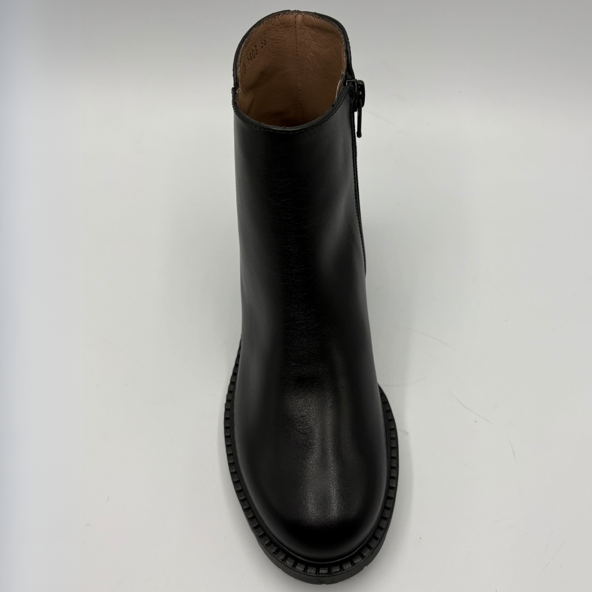 A black leather ankle boot with a side zipper, shown from a top-down perspective on a light gray background.