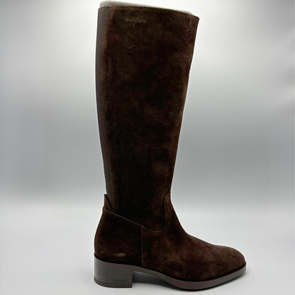 A single dark brown suede knee-high boot with a low block heel, shown in profile against a neutral gray background.