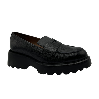 45 degree angled view of black textured leather penny loafer with chunky track sole