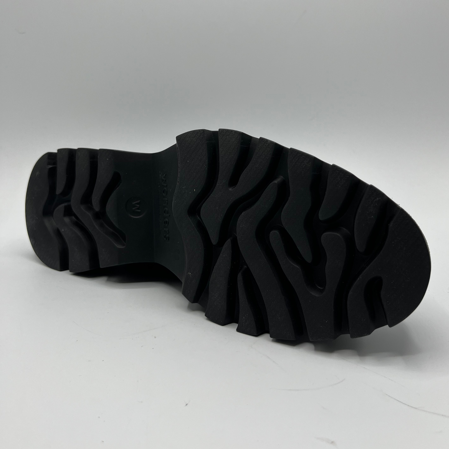 Black sole of a shoe on a gray background