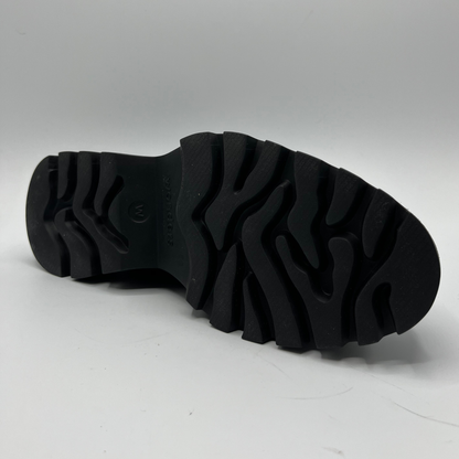 Black sole of a shoe on a gray background