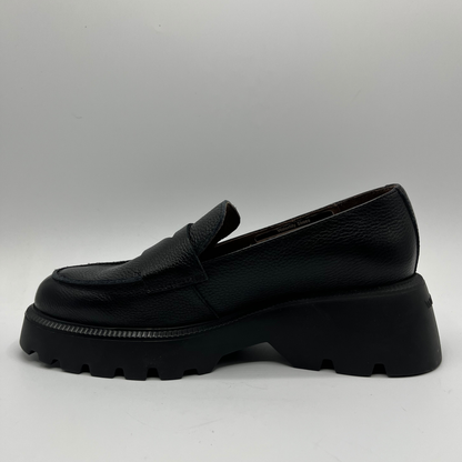 Black loafer shoe on a light gray background