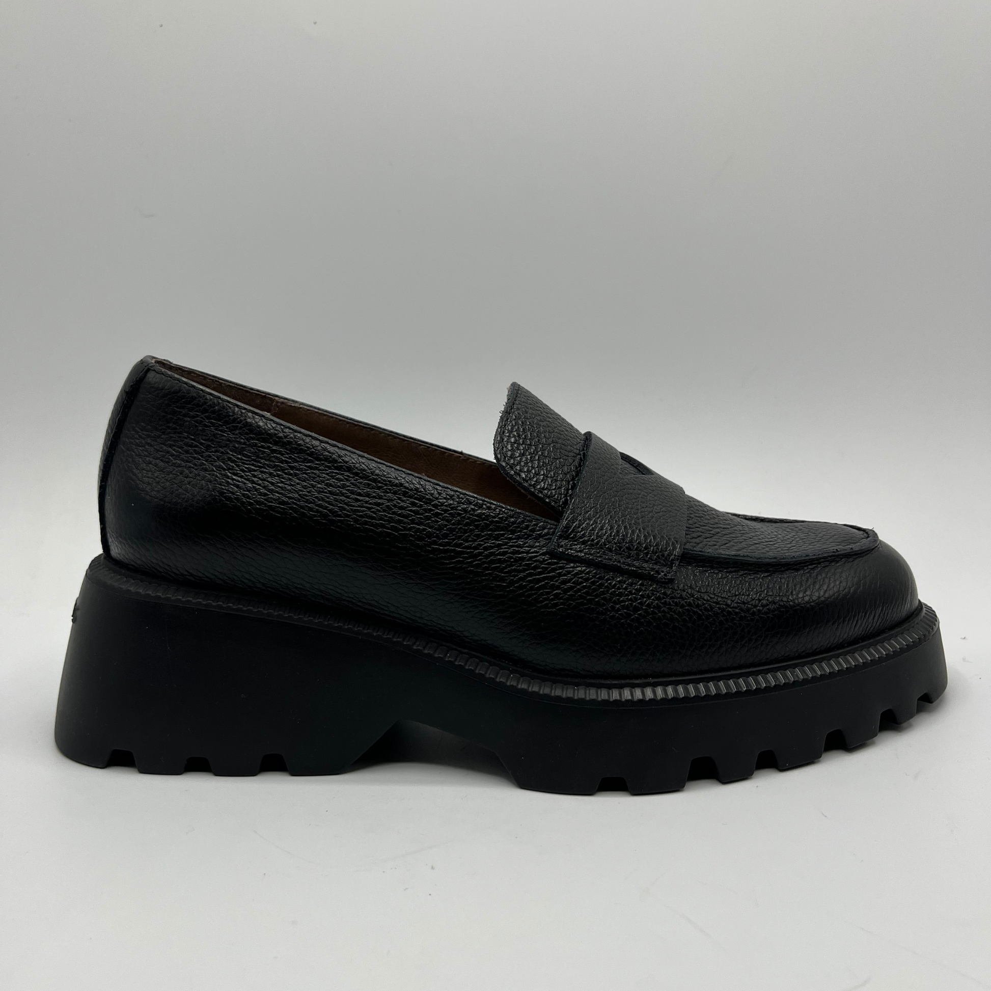 Black leather loafer shoe on a white background