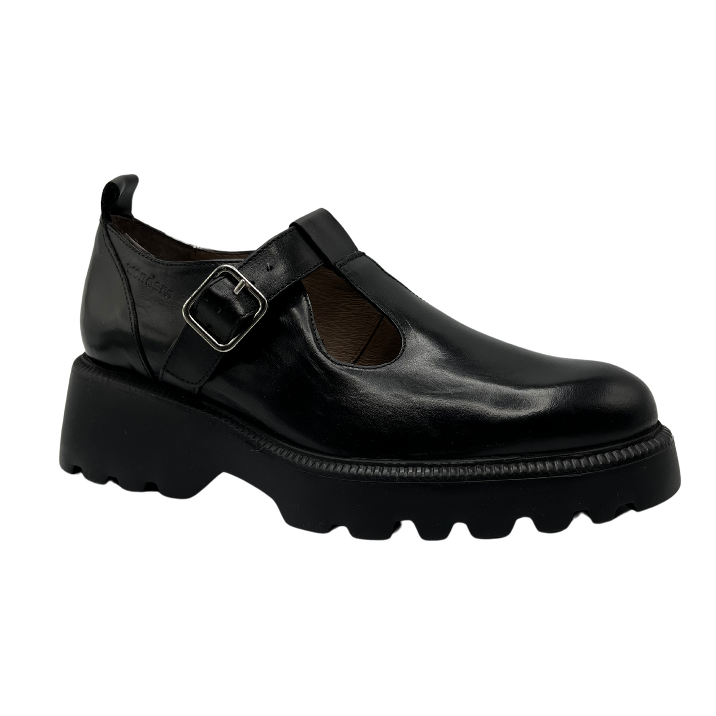 45 degree angled view of black leather t-strap shoe with chunky sole and silver buckle