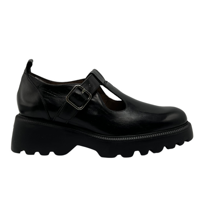 Right facing view of black leather t-strap shoe with chunky sole and silver buckle