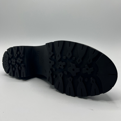 Black boot sole on a gray background