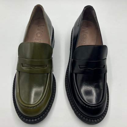 Pair of green and black loafers on a white background