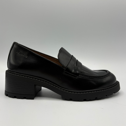 A single black leather penny loafer with a chunky block heel and lug sole, shown in profile against a neutral gray background.