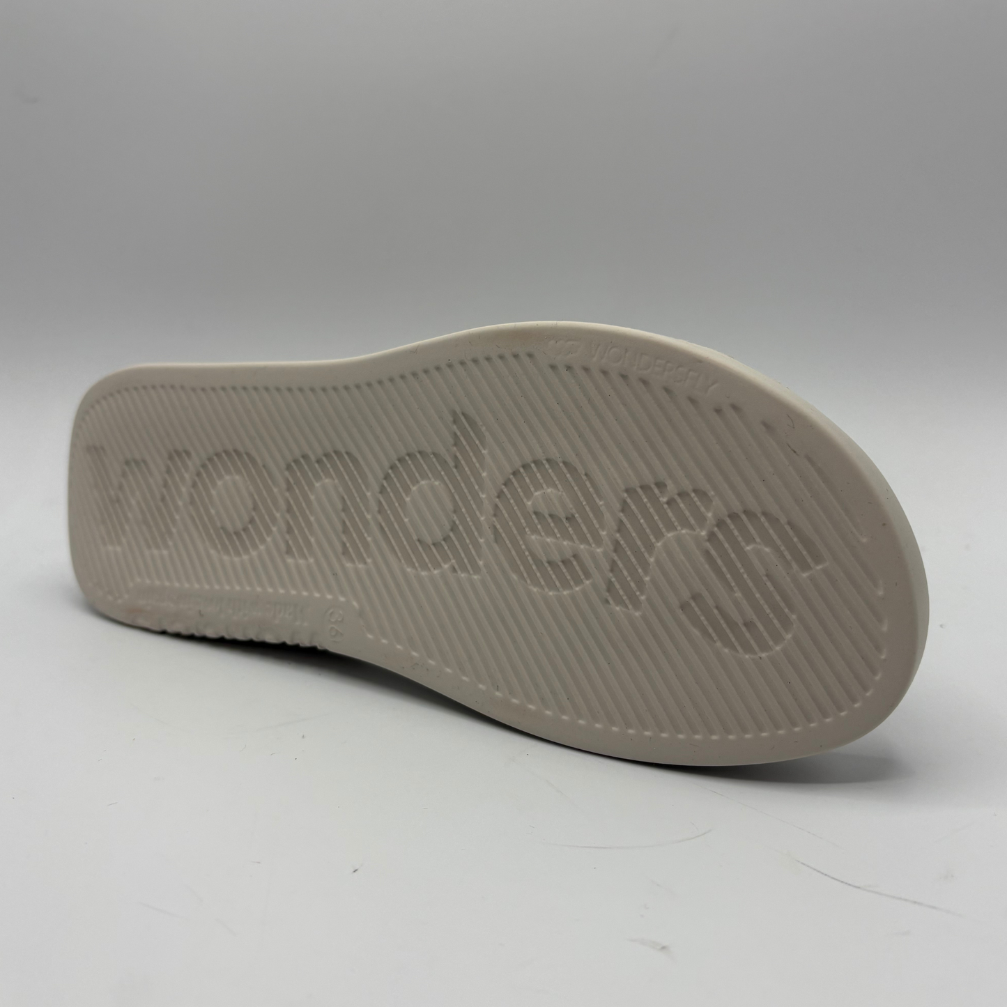 Gray sandal sole with 'Wonders' branding on a white background