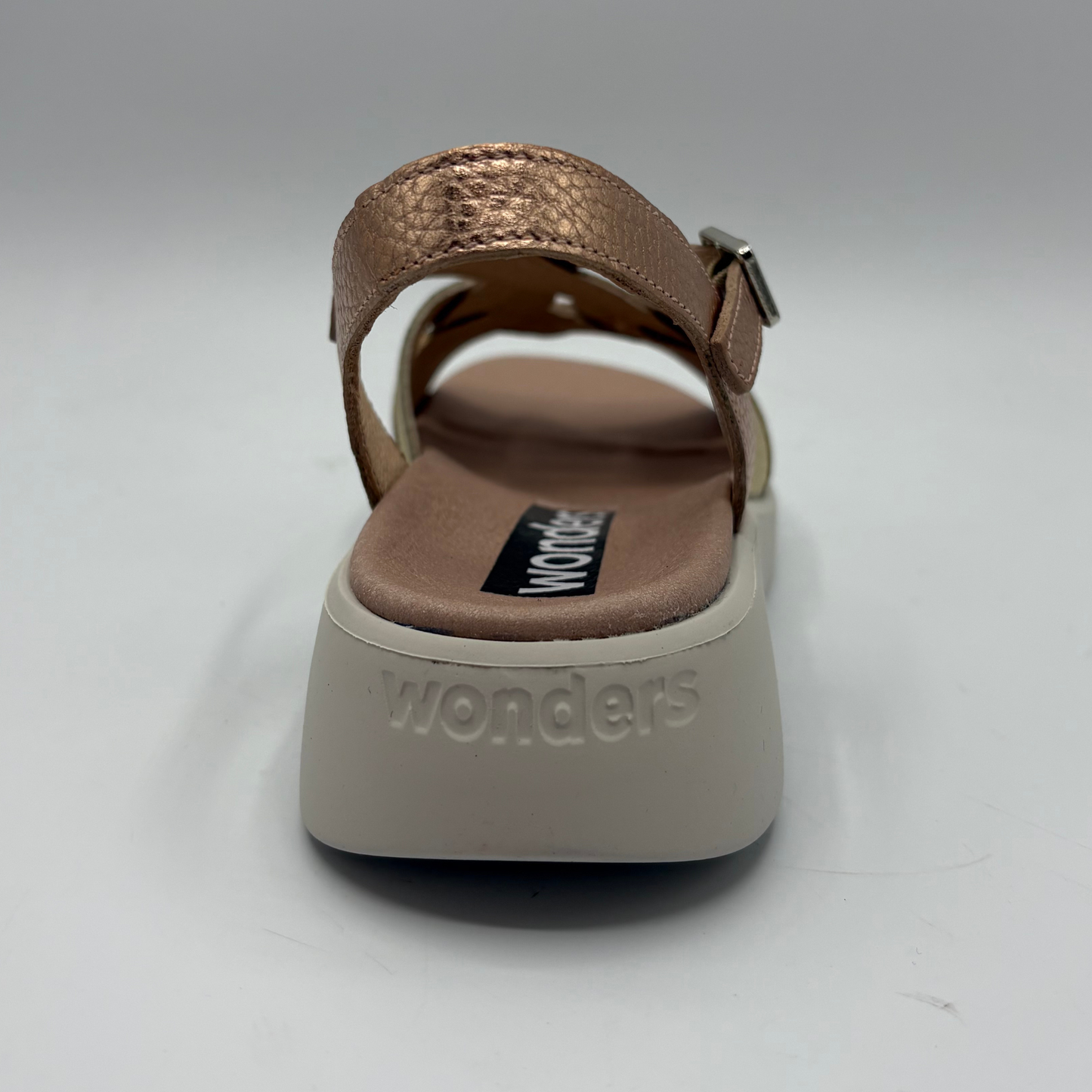 Brown sandal with 'wonders' branding on a white background