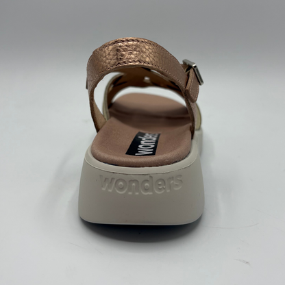 Brown sandal with 'wonders' branding on a white background