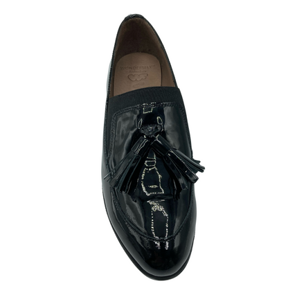 Top view of black patent leather loafer with wedge sole and double tassel on toebox