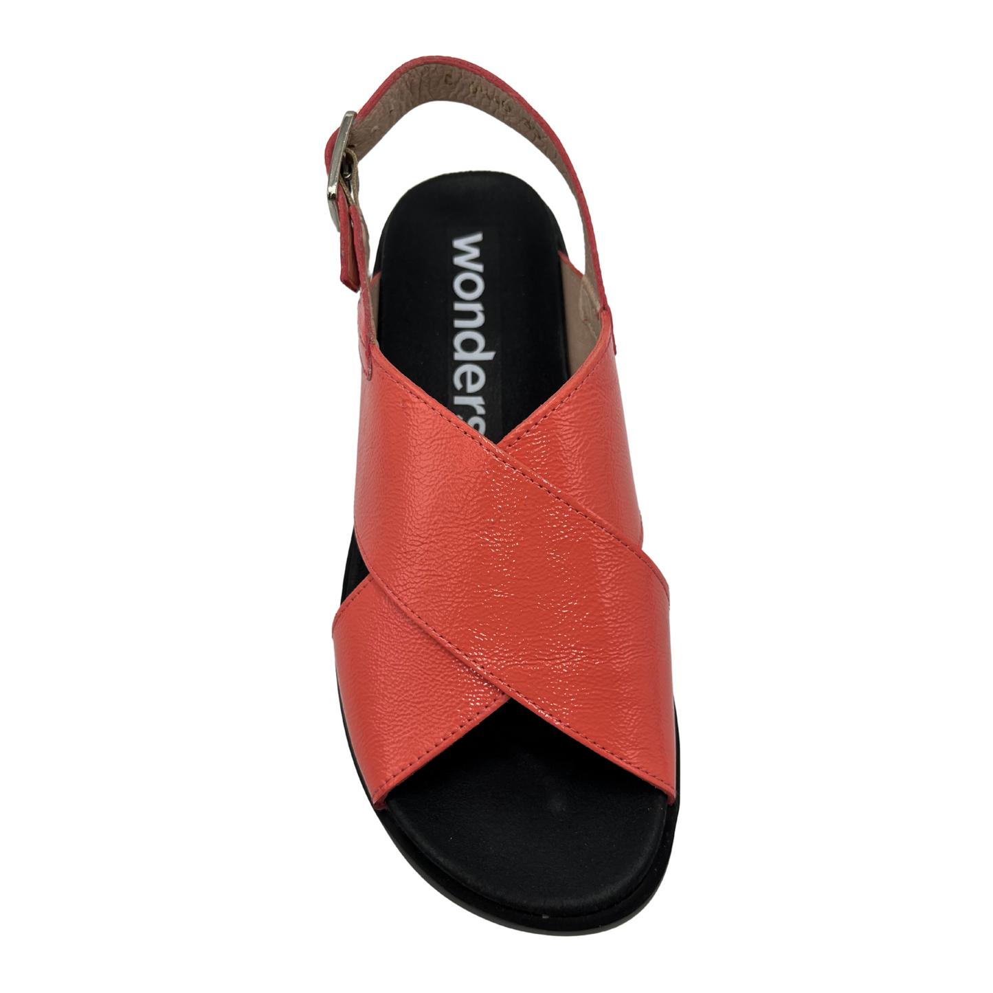 Top view of coral coloured leather sandal. Black outsole with a contoured footbed and adjustable slingback strap.