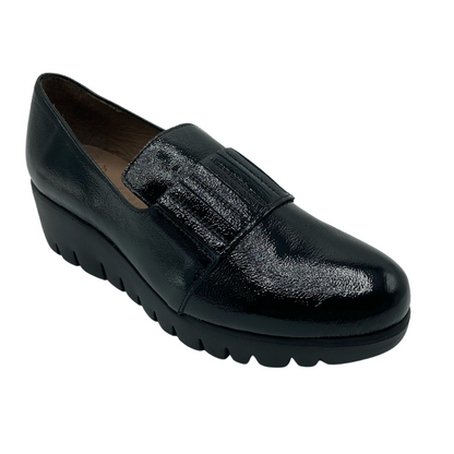 Angled view of engraved leather loafer with pull on tab