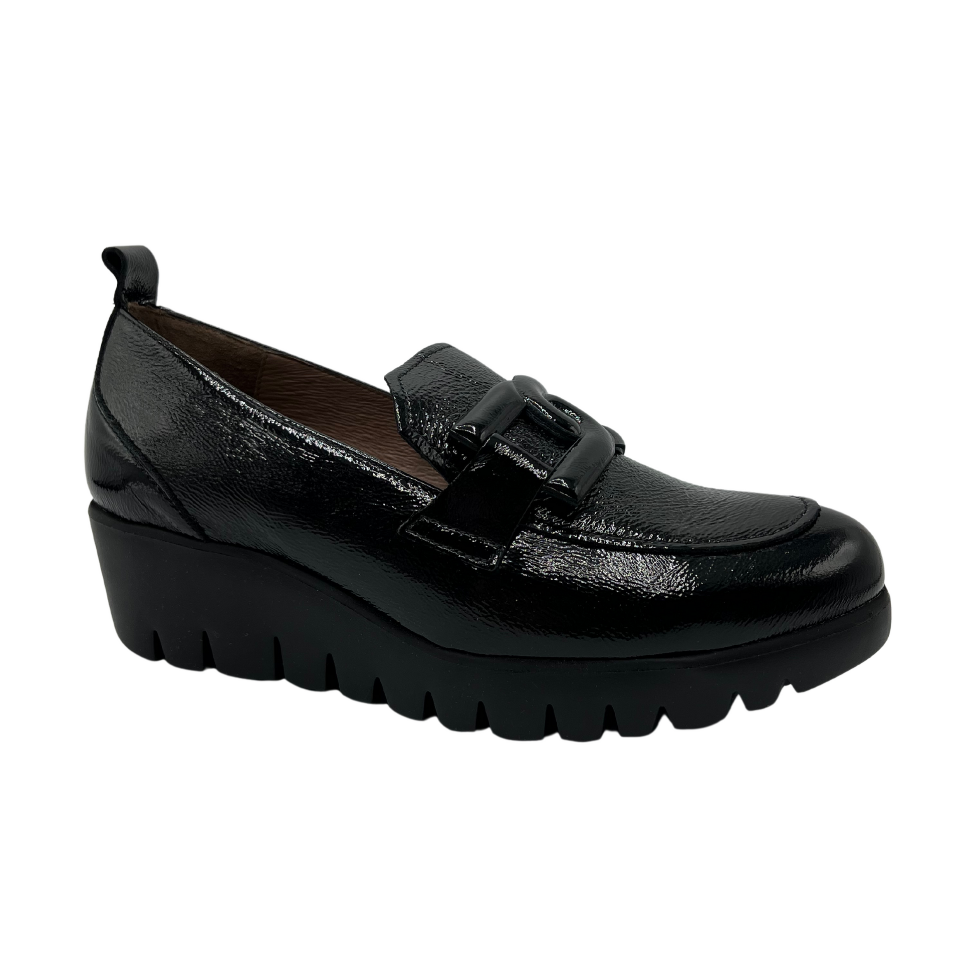 45 degree angled view of black patent leather loafer with wedge lug sole