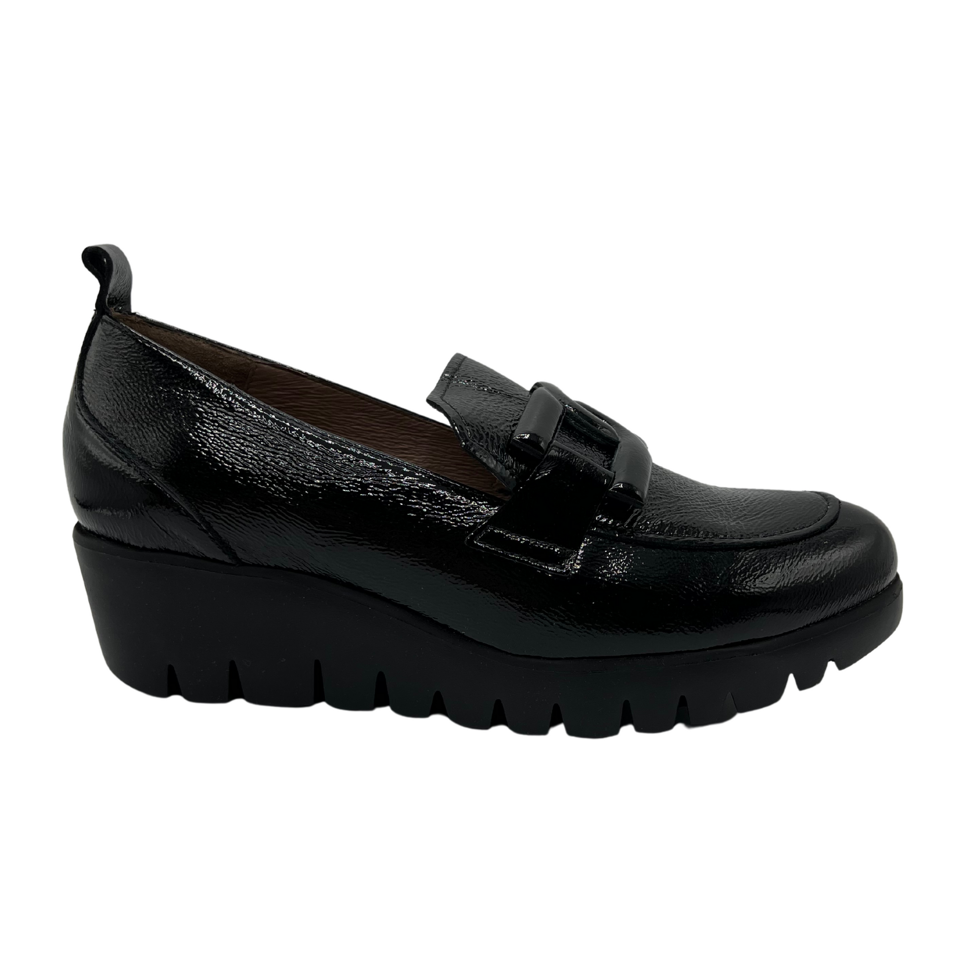 Right facing view of black patent leather loafer with wedge lug sole