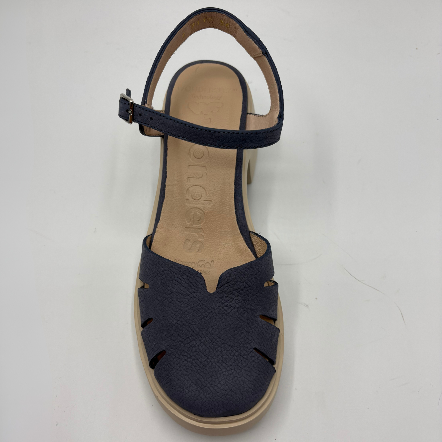 Navy blue sandal with cut-out design on a white background