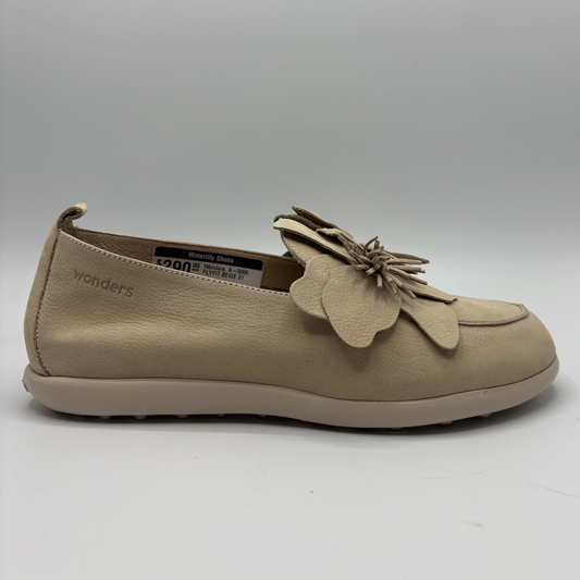 Beige shoe with floral design on a white background