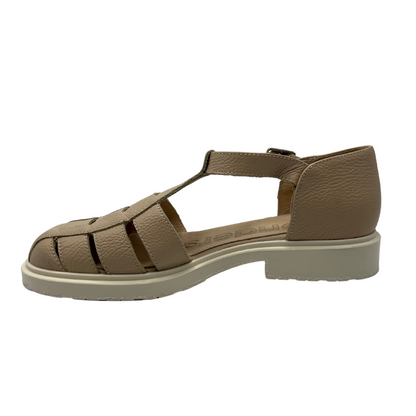 Left facing view of leather sandal with low heel and buckle strap