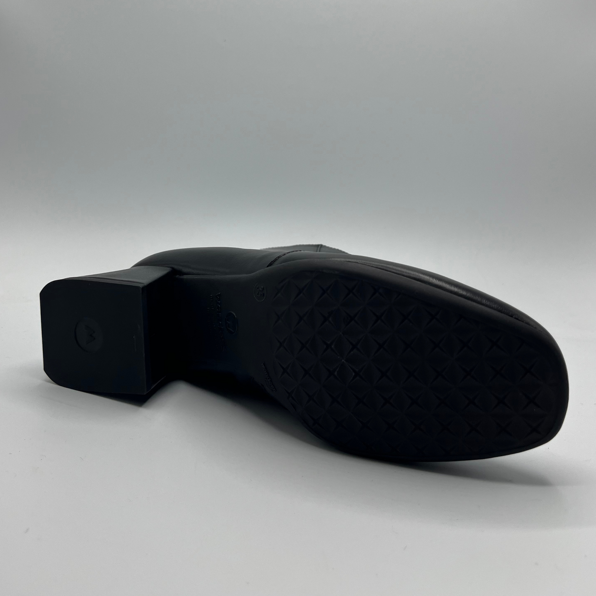 Black shoe sole on a light gray background
