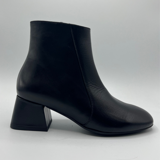 Black ankle boot on a light gray background