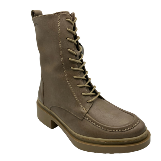45 degree angled view of brown leather short boot with rounded toe and rubber outsole