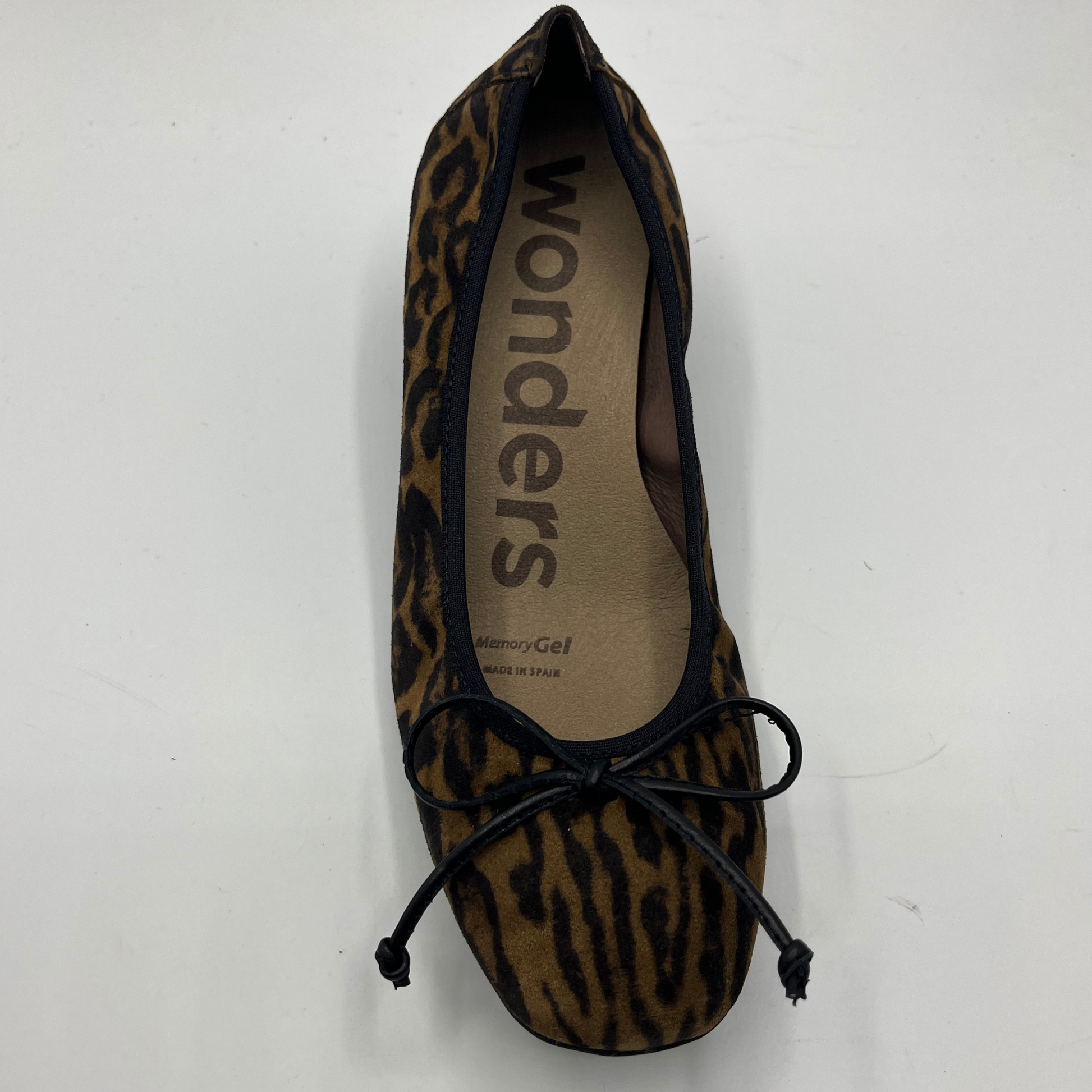 Leopard print flat shoe with 'wonders' branding on a white background