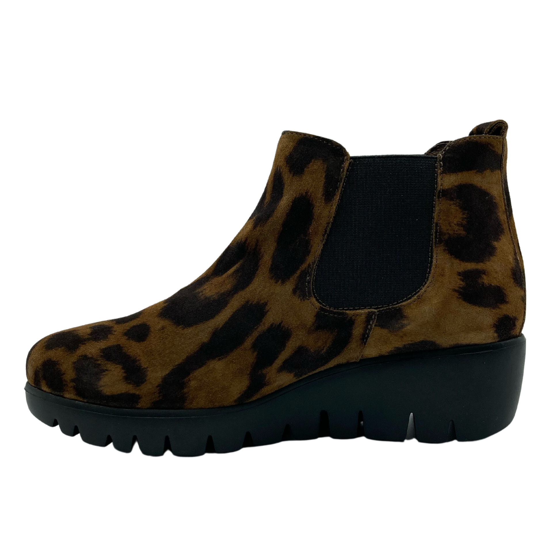 Left facing view of leopard print suede short boot with elastic side gore and black wedge heel