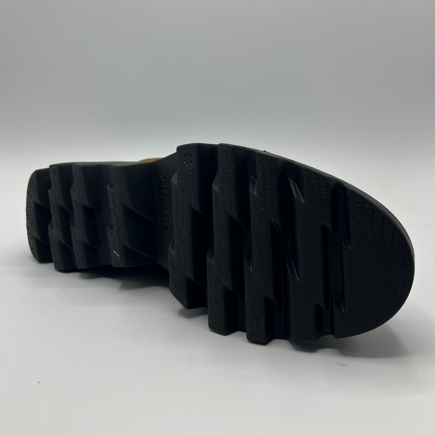 Close-up of a black rubber sole on a white background