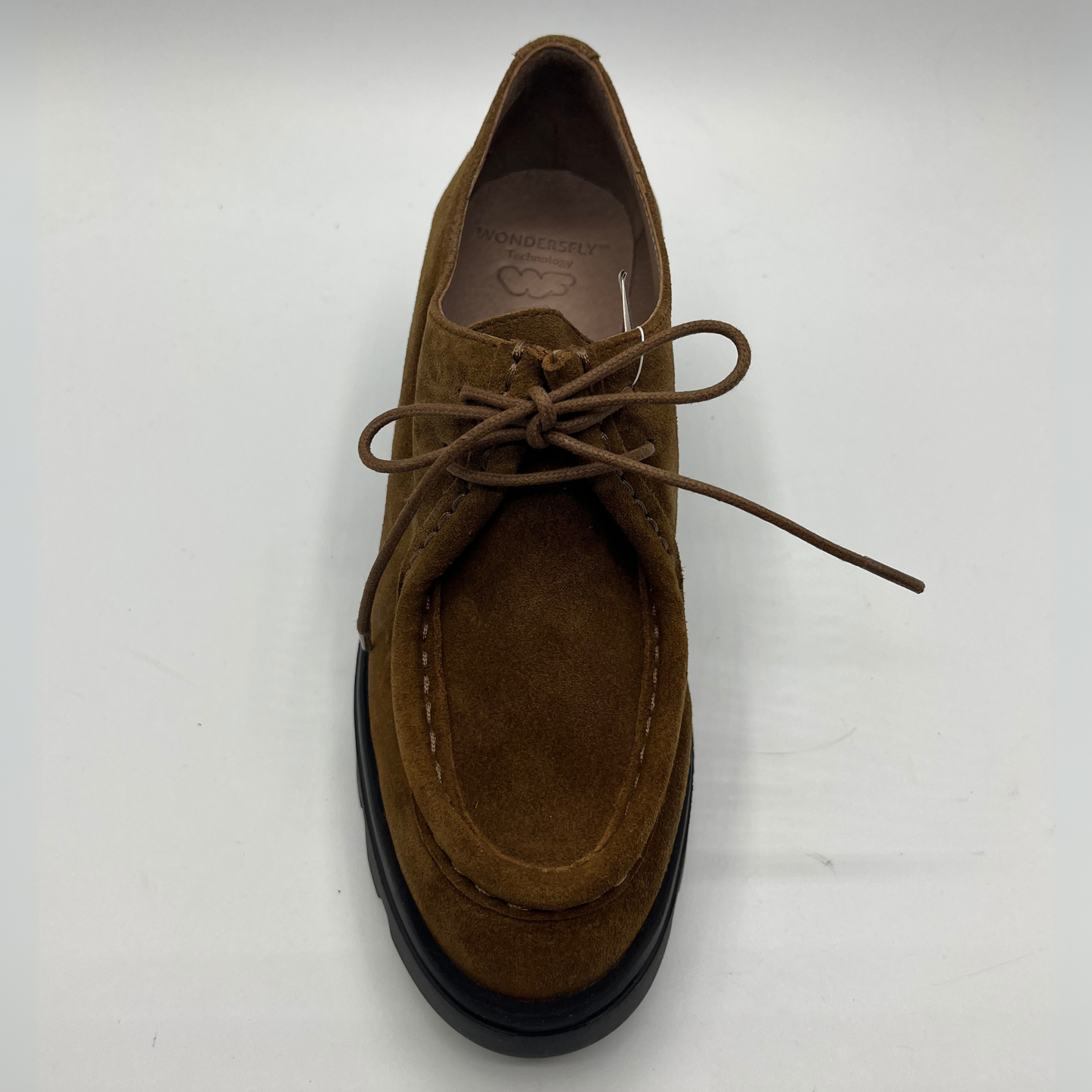 Brown suede shoe with black sole on a white background