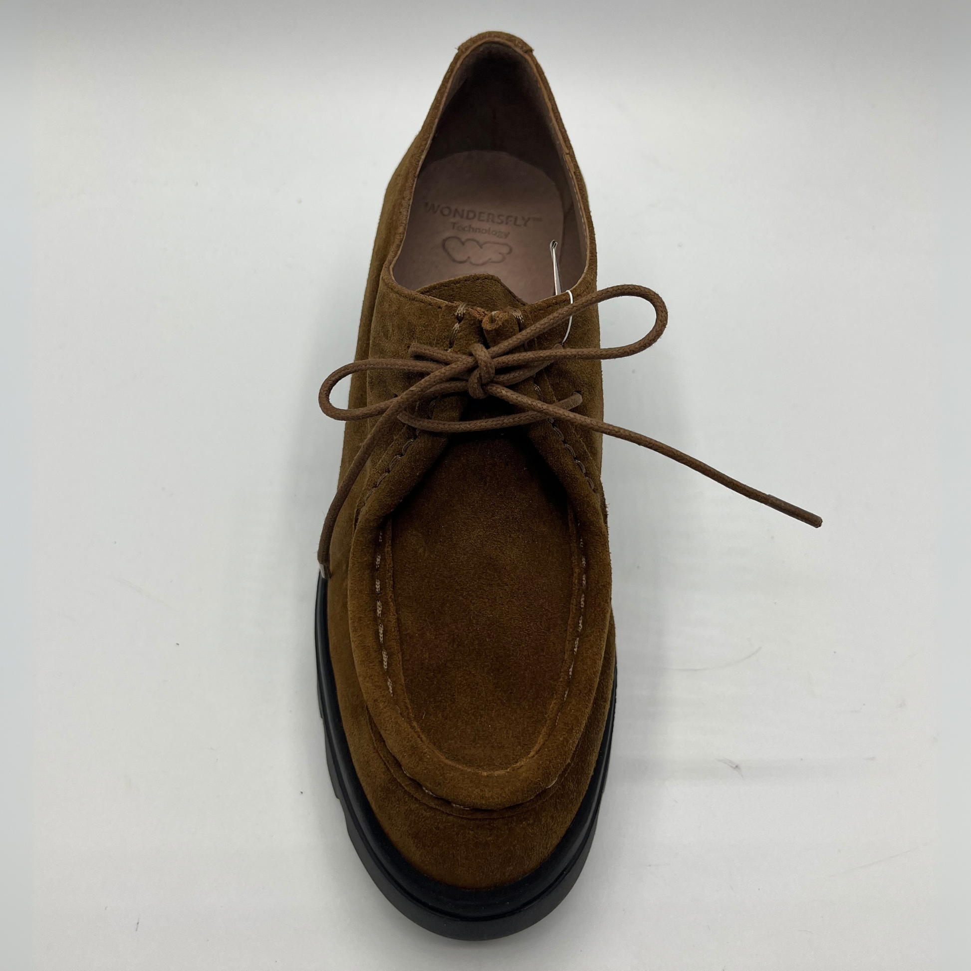 Brown suede shoe with black sole on a white background