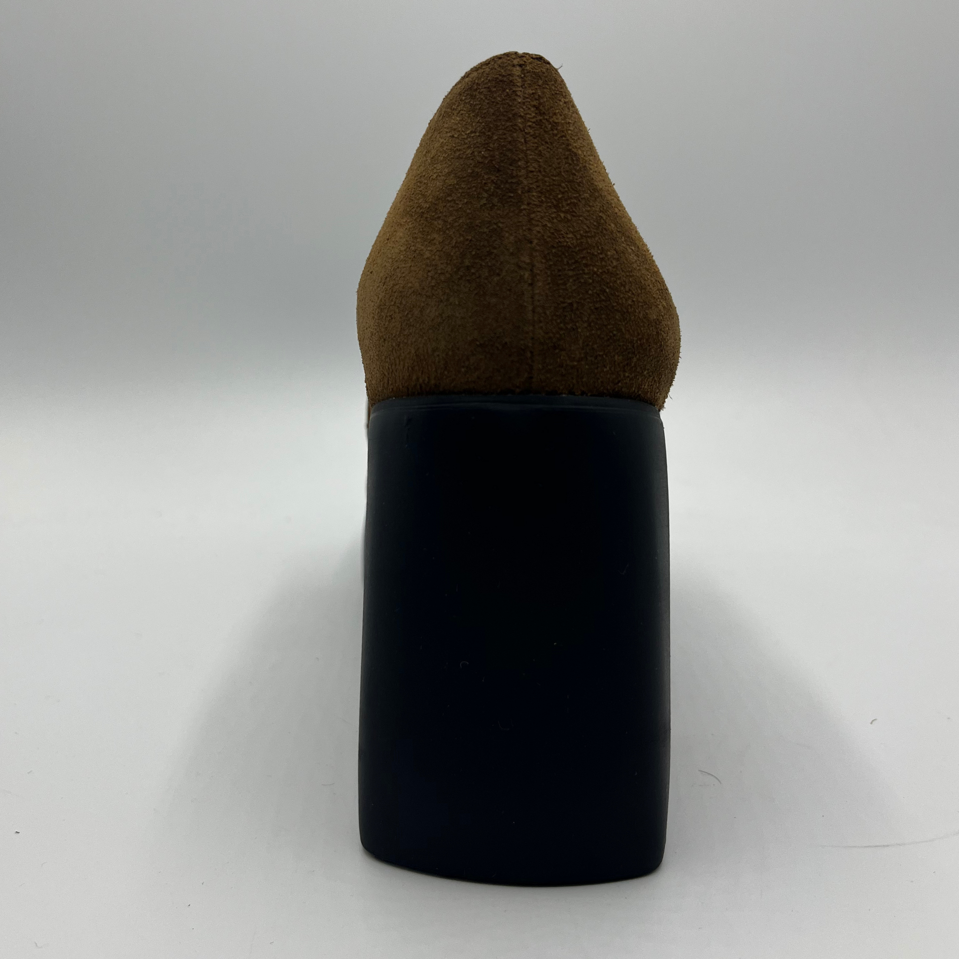 Brown suede high-heeled shoe with a black platform on a white background
