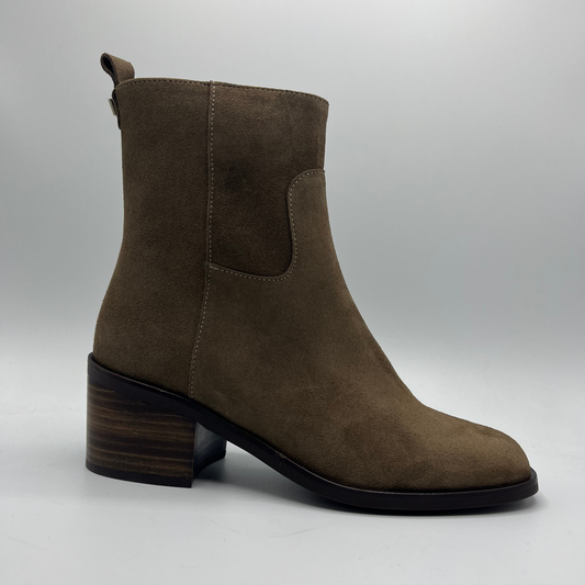 Brown suede ankle boot on a gray background