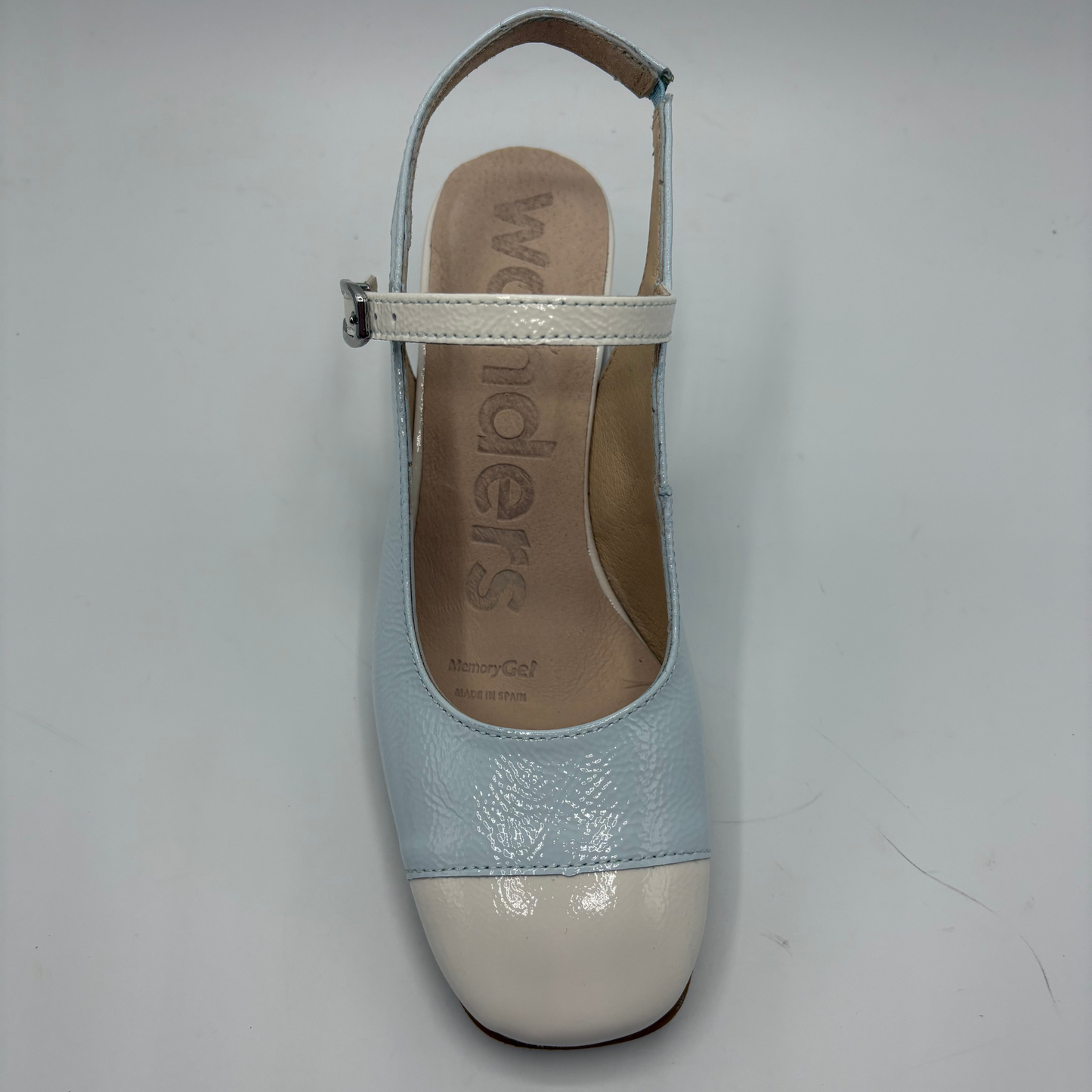 Light blue and white shoe with 'Wonders' branding on a gray background