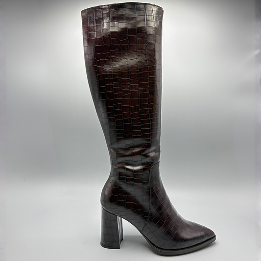 A single knee-high boot in glossy dark brown crocodile-embossed leather, shown from the side against a neutral gray studio background.