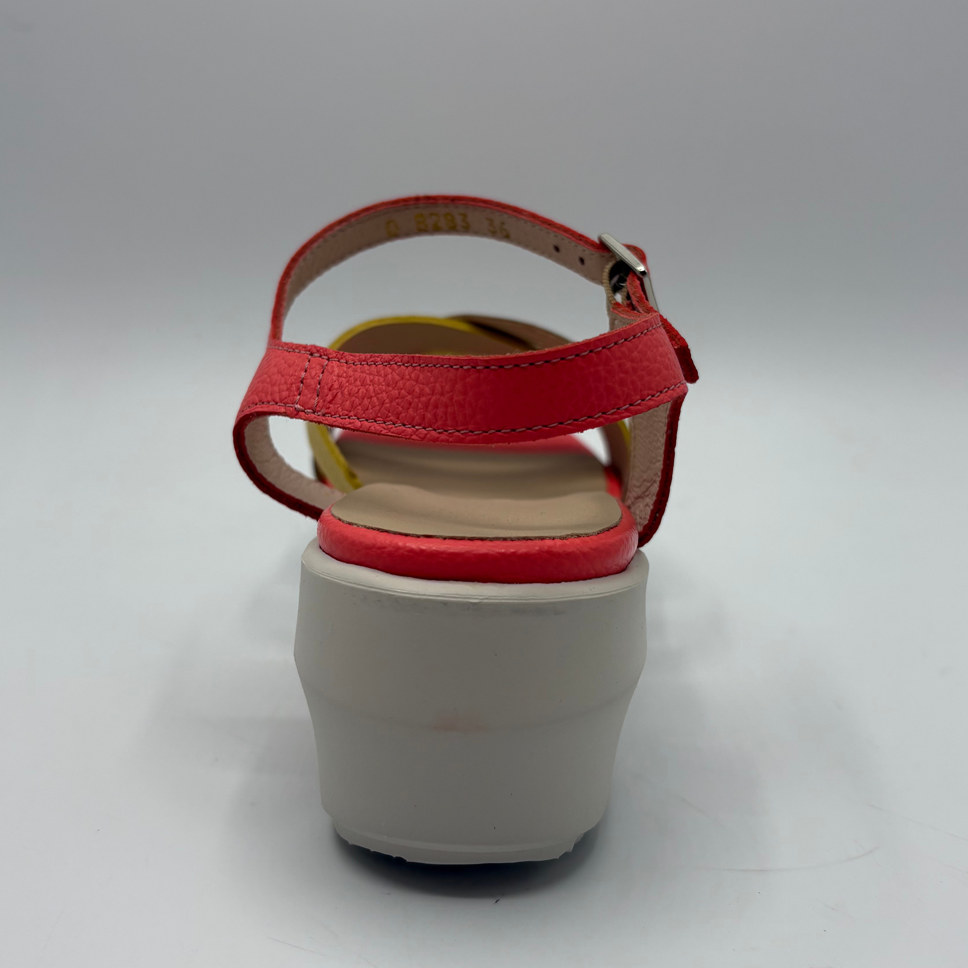 Red sandal with a white sole on a gray background