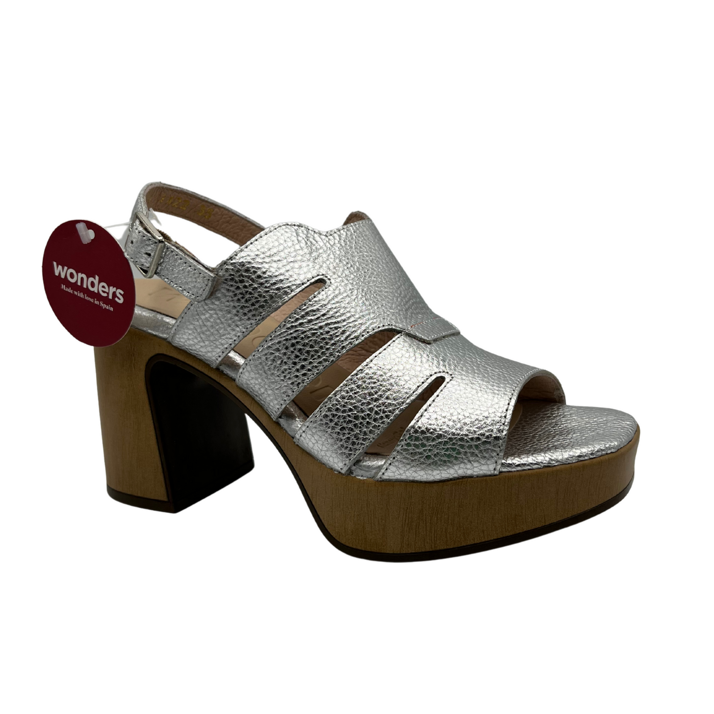 Angled view of a leather sandal in a silver colour with an open toe and adjustable slingback strap. Featuring a chunky block heel in a wood grain.