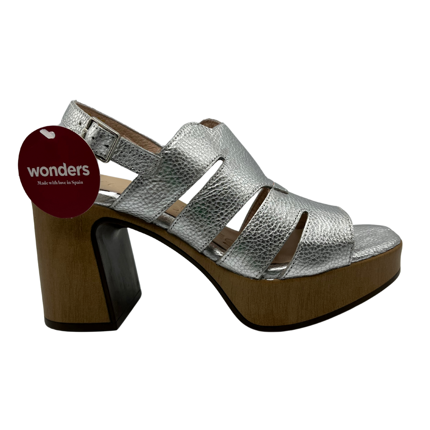 Right facing view of a leather sandal in a silver colour with an open toe and adjustable slingback strap. Featuring a chunky block heel in a wood grain.