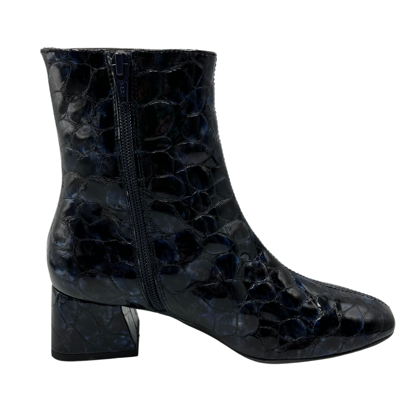 Right facing view of deep blue patent textured leather short boot. Short block, side zipper closure and rounded toe