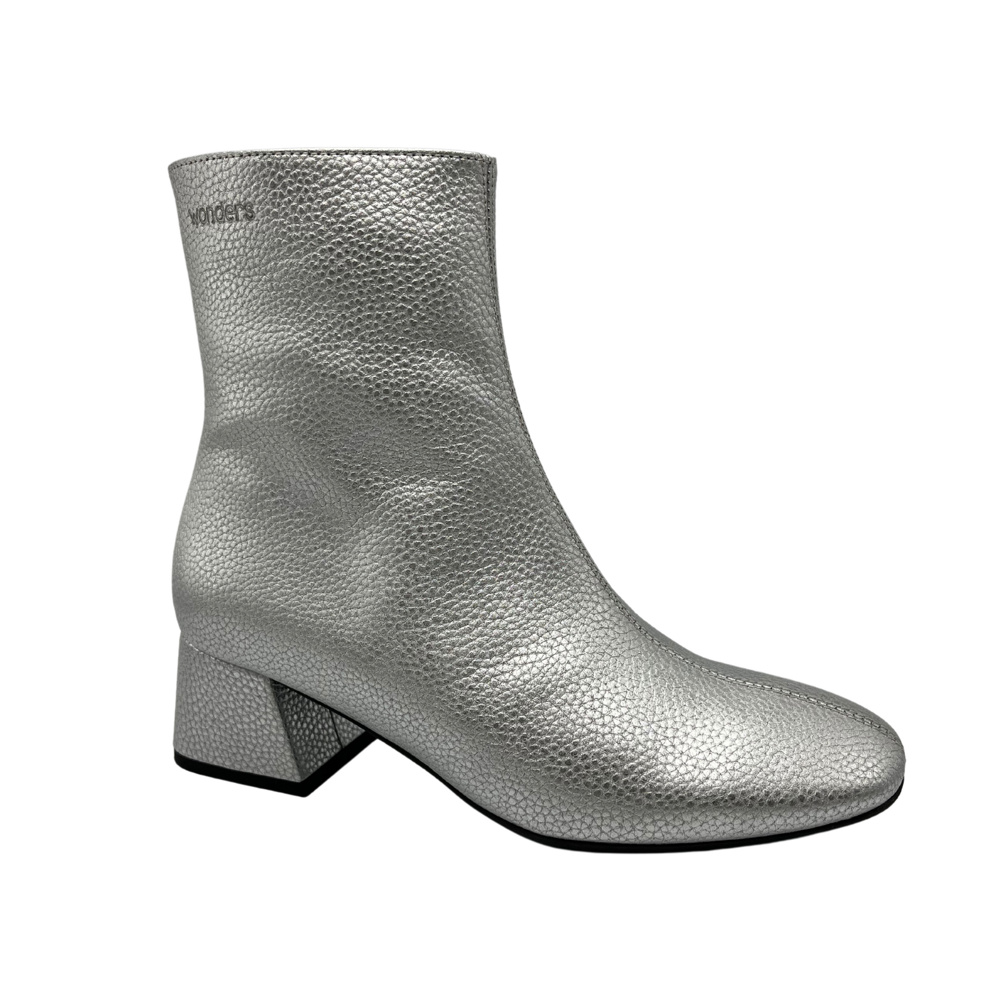 45 degree angled view of silver textured leather short boot. Short block, side zipper closure and rounded toe