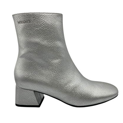 Right facing view of silver textured leather short boot. Short block, side zipper closure and rounded toe