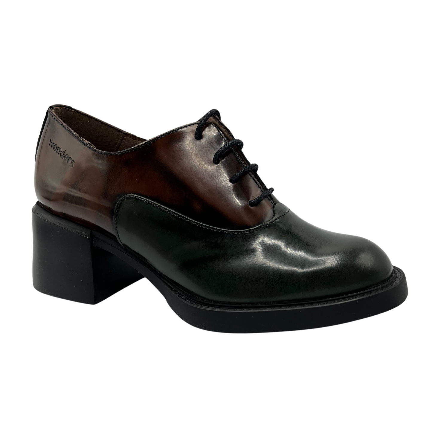 45 degree angled view of brown and green leather heels. Black outsole with a sturdy block heel