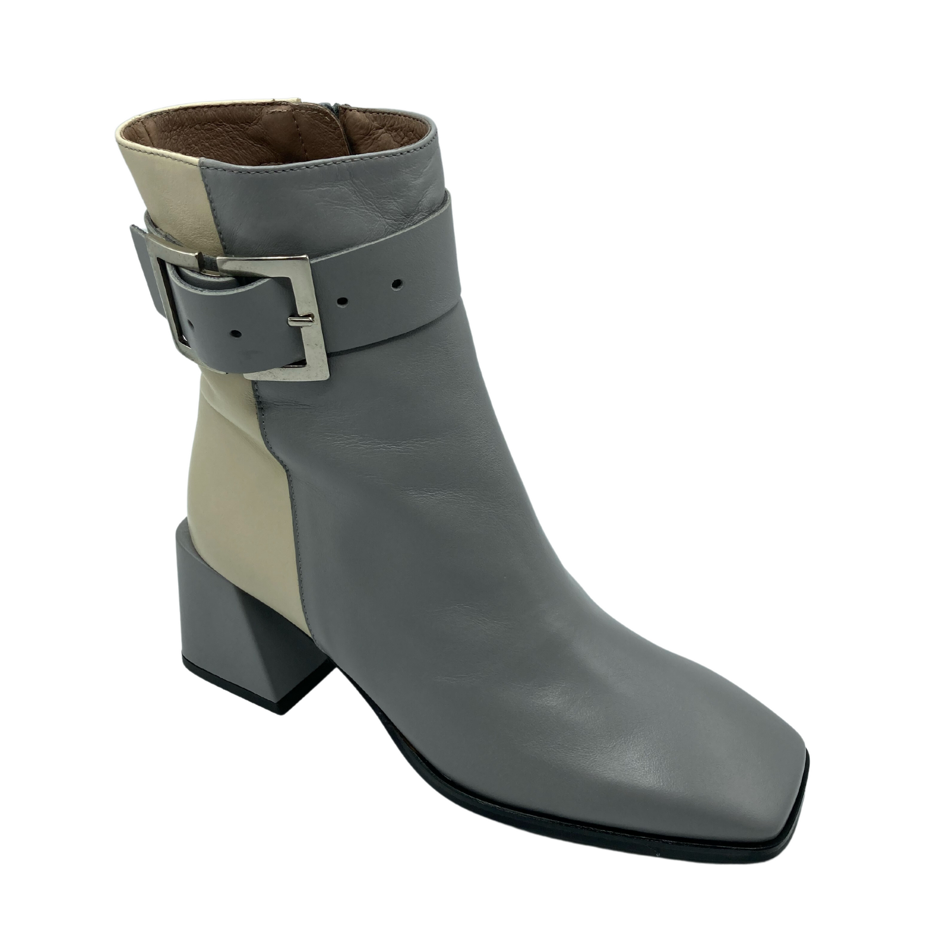 Angled view of grey and cream over the ankle boot with silver buckle on  the side